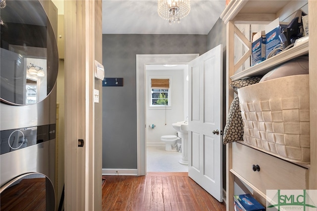 interior space featuring hardwood / wood-style floors, a notable chandelier, and toilet