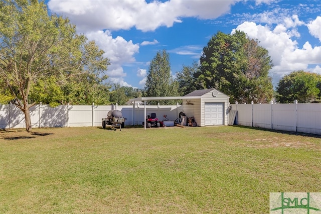 view of yard featuring a garage and an outdoor structure