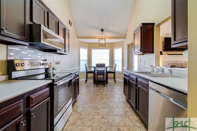 kitchen with lofted ceiling, sink, decorative light fixtures, appliances with stainless steel finishes, and a notable chandelier