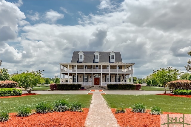 view of front of house featuring covered porch and a front yard