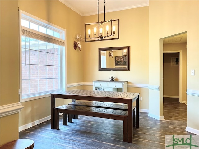 dining room with an inviting chandelier, dark wood-type flooring, and ornamental molding