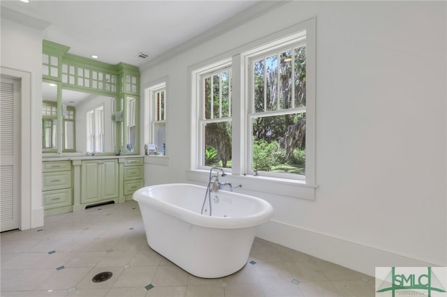 bathroom with vanity, ornamental molding, a washtub, and a wealth of natural light