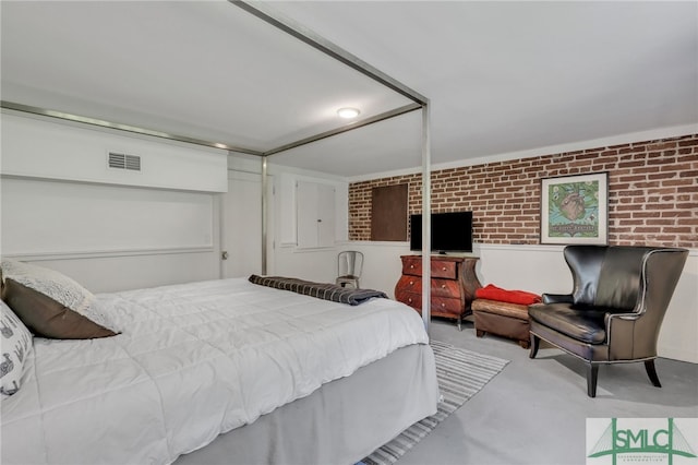 bedroom featuring brick wall