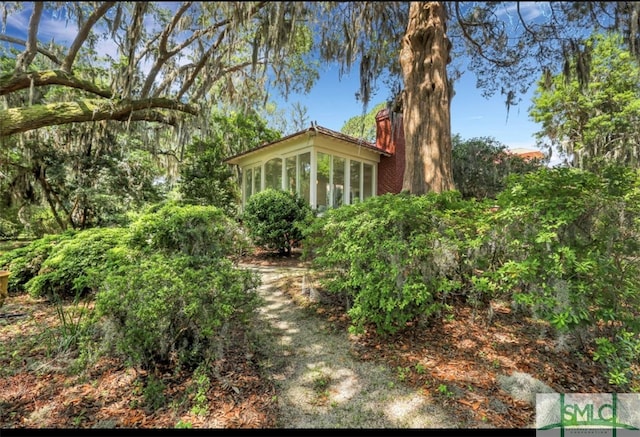 view of home's exterior featuring a sunroom