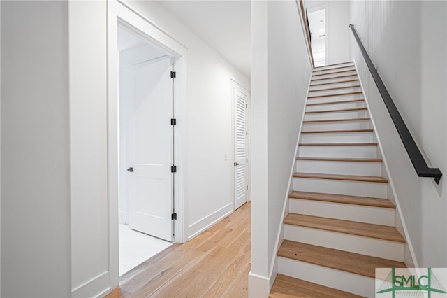 stairs with hardwood / wood-style flooring