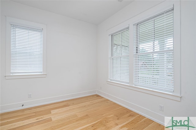 unfurnished room featuring light hardwood / wood-style flooring and plenty of natural light