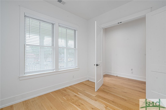 unfurnished room featuring hardwood / wood-style floors