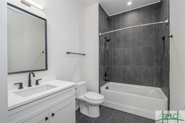 full bathroom featuring vanity, toilet, tiled shower / bath combo, and tile patterned flooring