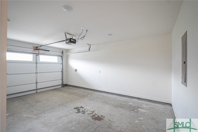 garage with a garage door opener and electric panel