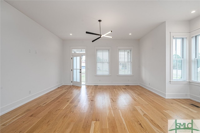 spare room featuring light hardwood / wood-style floors and ceiling fan