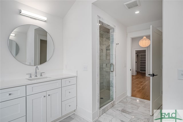 bathroom with vanity, hardwood / wood-style flooring, and an enclosed shower