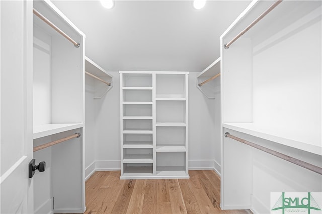 spacious closet with light hardwood / wood-style flooring