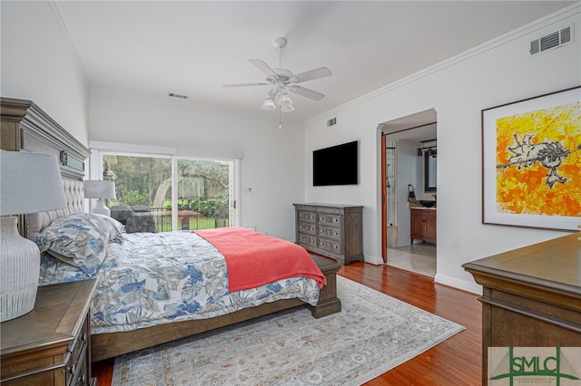 bedroom with ensuite bathroom, access to exterior, hardwood / wood-style floors, ceiling fan, and ornamental molding