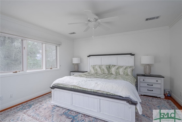 bedroom with ceiling fan, crown molding, and light hardwood / wood-style floors