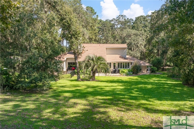 back of house featuring a yard