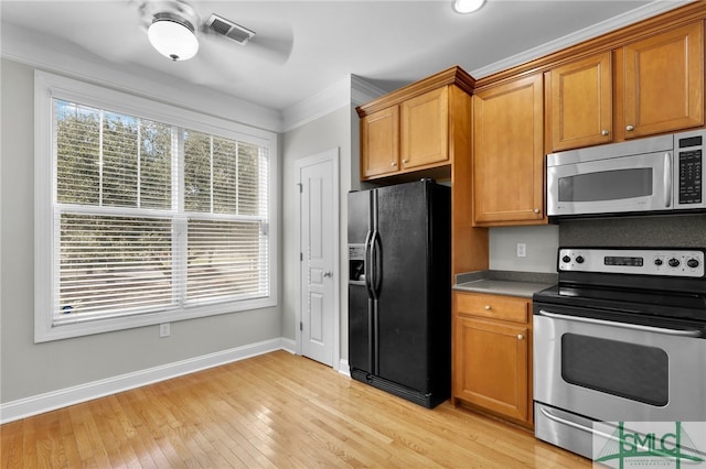 kitchen featuring stainless steel appliances, ornamental molding, and light hardwood / wood-style flooring