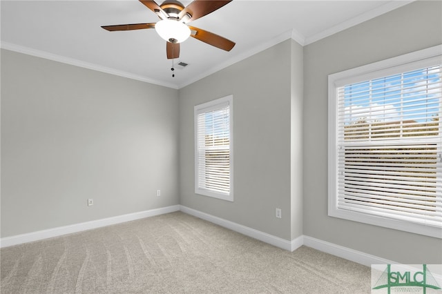 carpeted spare room with ornamental molding and ceiling fan