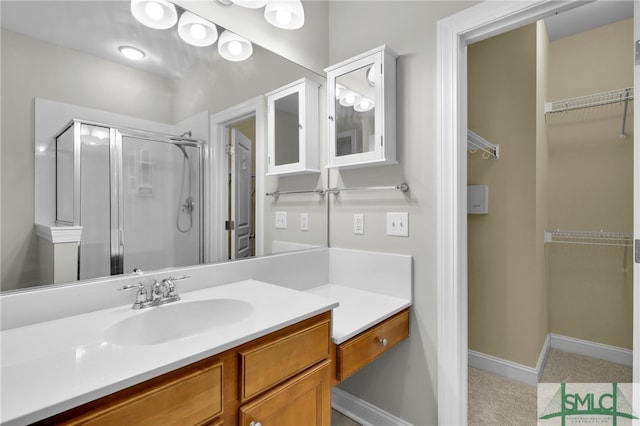 bathroom with vanity and a shower with shower door