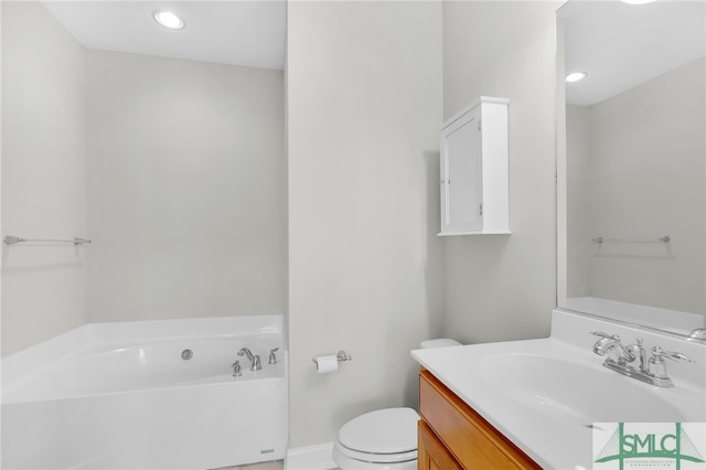 bathroom featuring vanity, toilet, and a tub