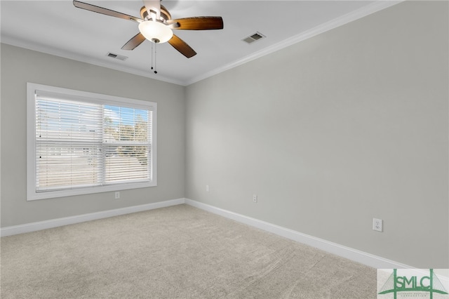 carpeted spare room featuring crown molding and ceiling fan