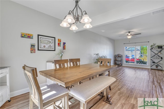 dining area featuring light wood-type flooring and ceiling fan with notable chandelier