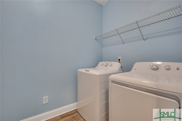 washroom featuring washer and dryer and light hardwood / wood-style floors