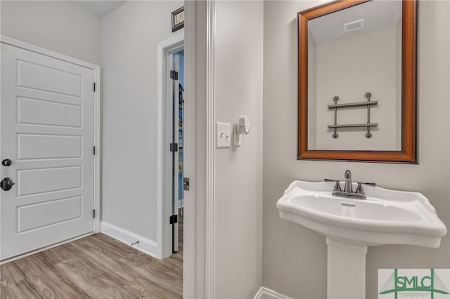 bathroom with hardwood / wood-style flooring and sink