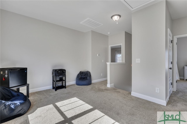 sitting room featuring light carpet