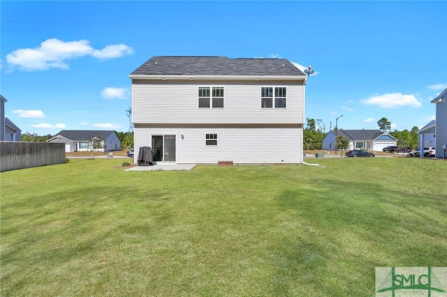 back of property with a patio and a lawn