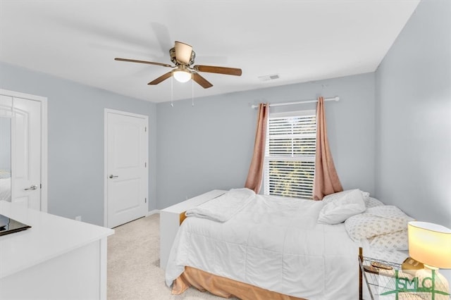 bedroom with light carpet and ceiling fan