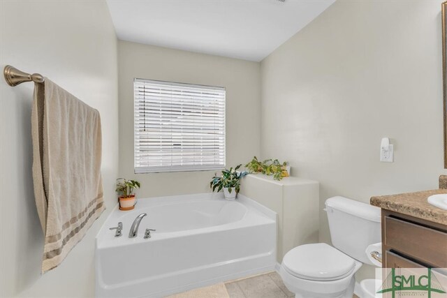 bathroom with vanity, tile patterned flooring, toilet, and a washtub