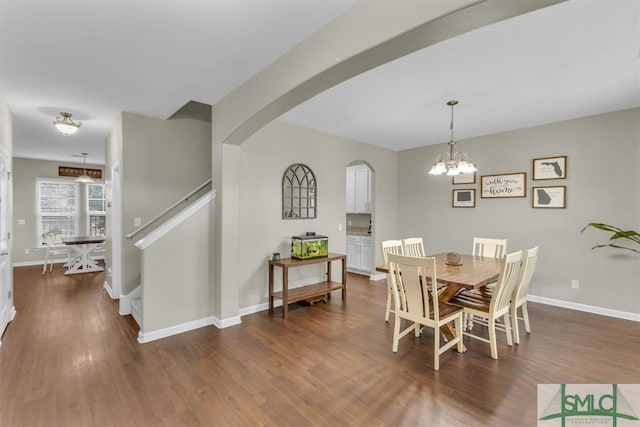 dining space with an inviting chandelier and dark hardwood / wood-style floors