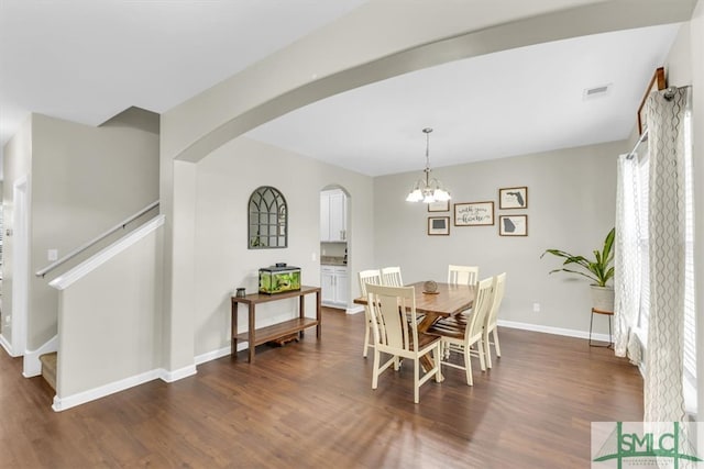 dining area with a notable chandelier and dark wood-type flooring