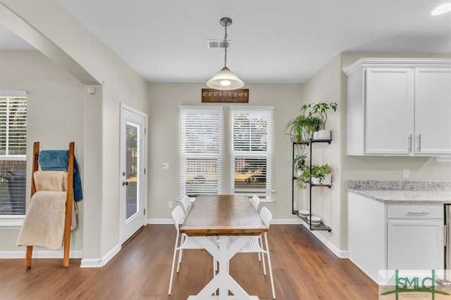 dining space with dark hardwood / wood-style floors