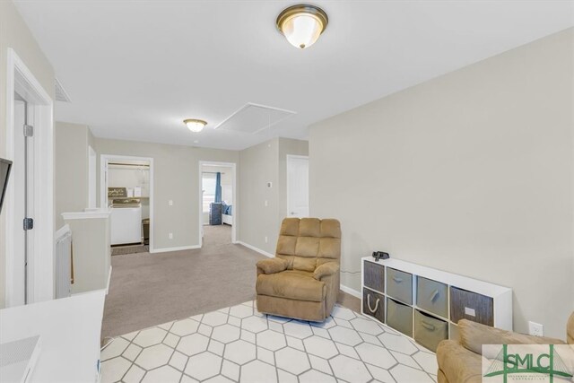 living area with light colored carpet and washer / clothes dryer