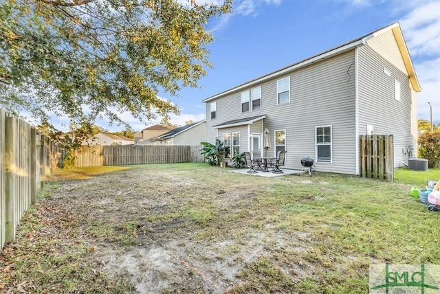 back of house featuring central AC, a yard, and a patio area