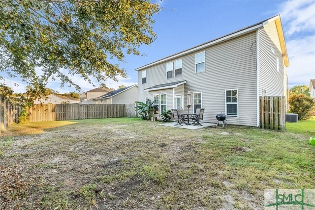 back of property with a yard, a patio area, and central air condition unit