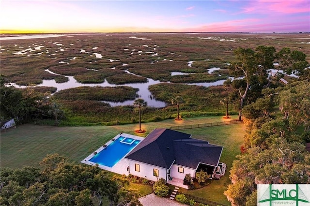 aerial view at dusk with a water view