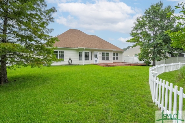 back of house with a patio and a yard