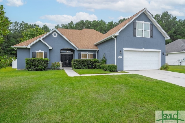 view of front of house featuring a front yard and a garage