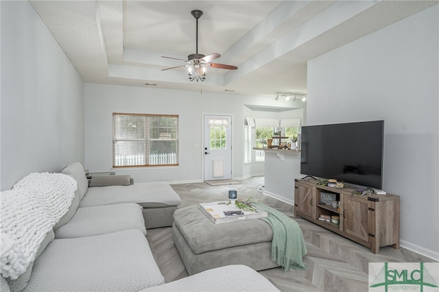 living room featuring light parquet floors, a healthy amount of sunlight, and ceiling fan