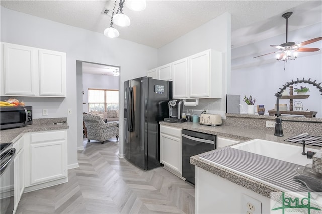 kitchen featuring stainless steel microwave, ceiling fan, black fridge, dishwasher, and white cabinets