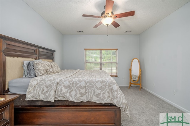 bedroom featuring ceiling fan, a textured ceiling, and carpet floors