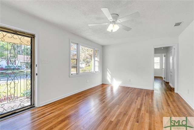 interior space featuring light hardwood / wood-style floors, a textured ceiling, and ceiling fan