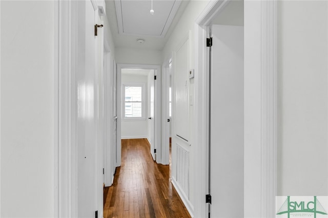 corridor with dark hardwood / wood-style flooring