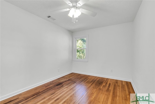 unfurnished room with a textured ceiling, hardwood / wood-style flooring, and ceiling fan