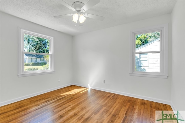 spare room featuring hardwood / wood-style floors, a textured ceiling, and ceiling fan