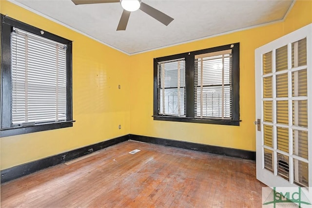 spare room with ceiling fan, hardwood / wood-style floors, and ornamental molding