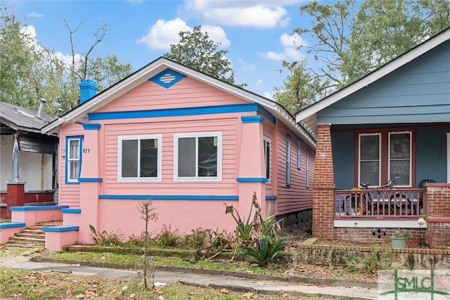 view of side of property with a porch