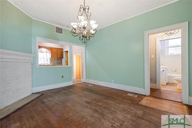 unfurnished dining area featuring a chandelier, a wealth of natural light, dark wood-type flooring, and ornamental molding